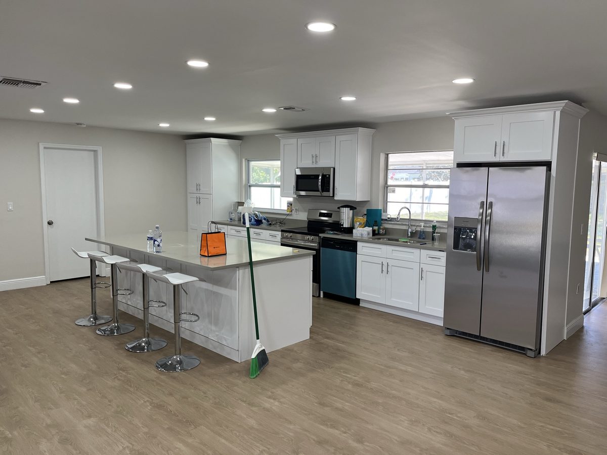 White kitchen with a large center island and quartz countertops