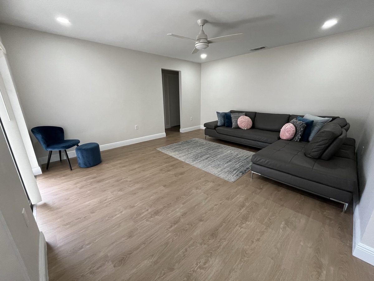 Furnished living room with a sectional sofa, accent chair and wood-look flooring