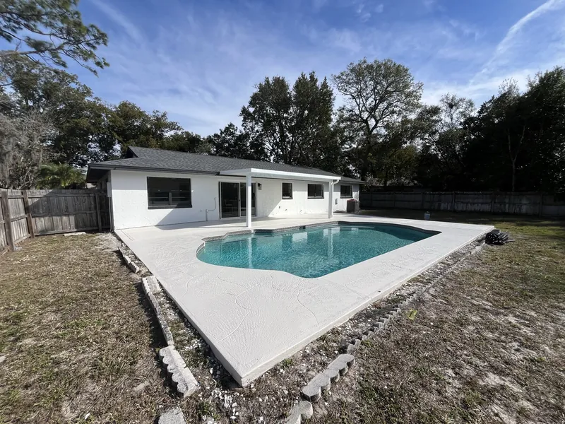 Renovated single-family home with a finished pool and paver patio