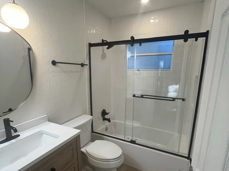 Renovated bathroom with a glass shower and a floating vanity